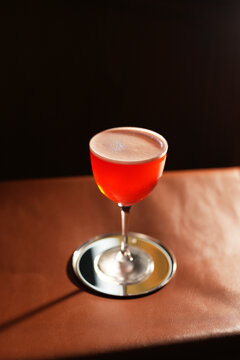 Red Alcoholic Sour Cocktail with Foam in Stemmed Glass Close Up