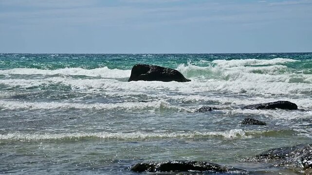 Ocean waves crashing against rocks on rocky coast