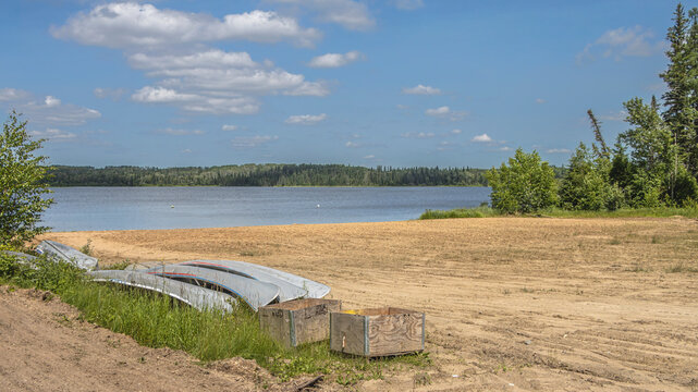 Canoes Resting on Sandy Beach at Anglin Lake in Saskatchewan, Canada