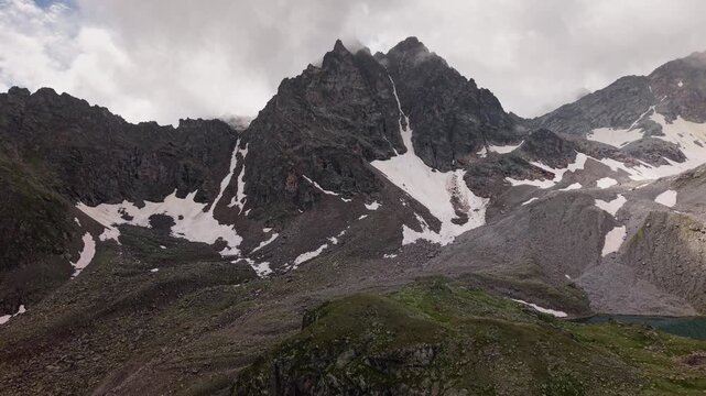 Aerial view of rocky snow dusted mountain peak