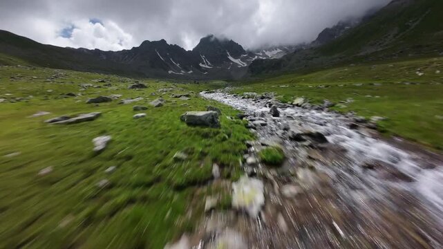 Fast forward movement along mountain stream in valley