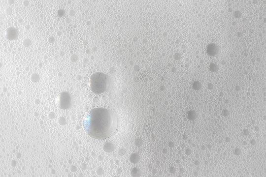 Abstract background white soapy foam texture. Shampoo foam with bubbles
