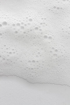 Abstract background white soapy foam texture. Shampoo foam with bubbles