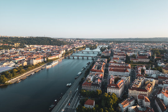 Aerial view of Prague Castle overlooking the Vltava River and the historic city center with red-tiled rooftops and bridges in Prague, Prague, Czechia.