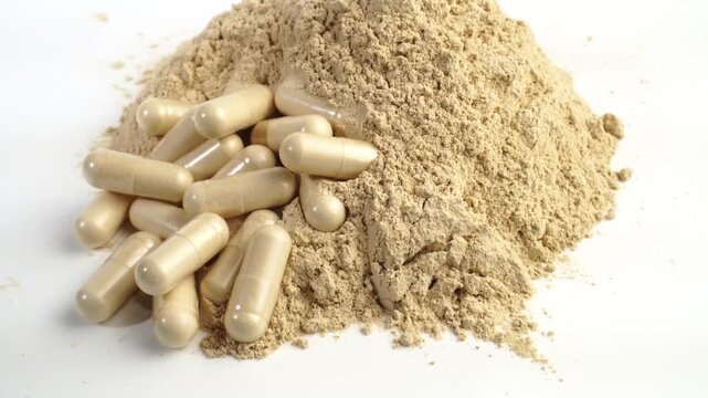 Ashwagandha powder and pills as supplement isolated on white background