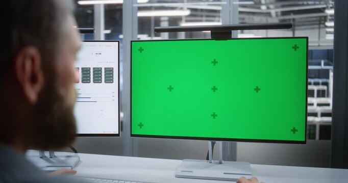 IT Professional Reviewing Customizable Monitor Interface in High Tech Workplace, Illustrating System Troubleshooting, Digital Operations, Enterprise Computing, and Adaptable Technology Workflows.