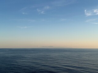 Fototapeta premium France, Cap Corse seen from cruise ship balcony on summer evening to Naples, Italy - Pastel Ligurian Mediterranean Sea after sunset