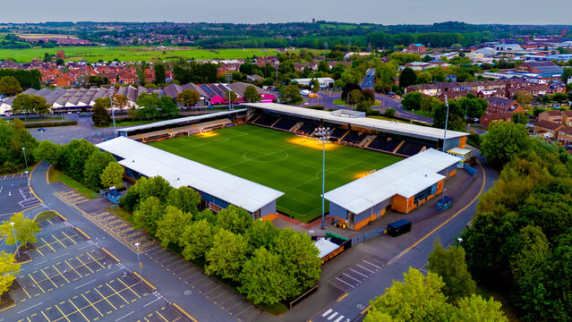 Aerial view of football stadium and surrounding town landscape