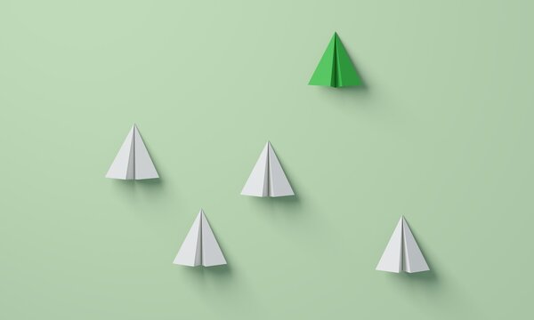 Green paper plane leading white planes upwards
