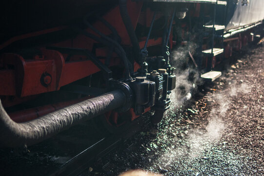 View of the Albatros 498 104 steam locomotive emitting steam at the Zvolen railway station in Zvolen, Banskobystricky kraj, Slovakia.
