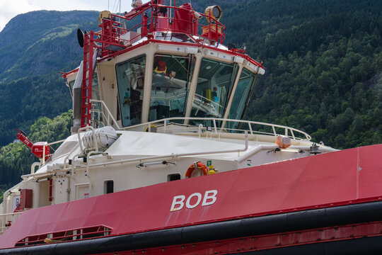 August 16, 2026, Odda, Norway - Red and white tugboat named "BOB" in a fjord