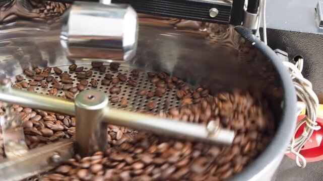 The cooling process of freshly roasted coffee beans, cooled using sucked air in the cooling tray of the coffee roasting machine