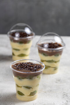 Layered Brazilian Grape and Chocolate Dessert Cups on Light Background
