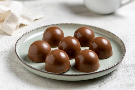 Gourmet Milk Chocolate Bonbons and Chocolate Truffles on Ceramic Plate