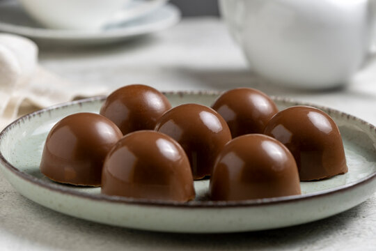 Gourmet Milk Chocolate Bonbons and Chocolate Truffles on Ceramic Plate