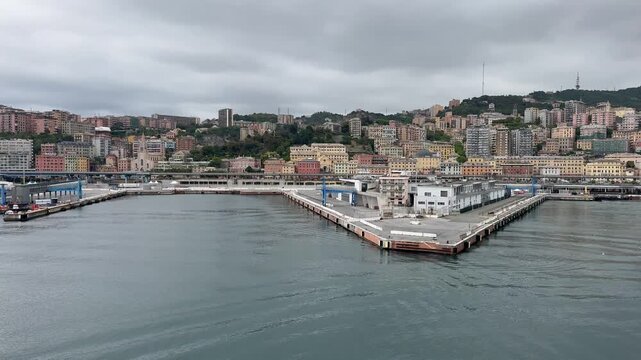 26 April 2026, Italy, Liguria, Genoa, Port Cruise Terminal - MSC World Europa slowly departing viewing harbor skyline waterfront and Ponte Andrea Doria