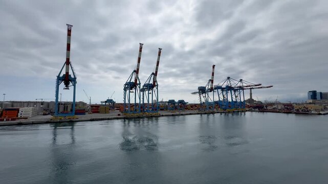 26 April 2026, Italy, Liguria, Genoa, Port Terminal Contenitori - PSA SECH STS cranes semi-circular beam seaport gantry for unloading and loading infrastructure 