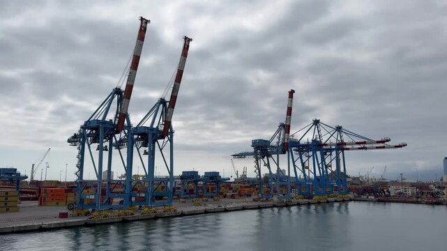 26 April 2026, Italy, Liguria, Genoa, Port Terminal Contenitori - close up of PSA SECH STS cranes semi-circular beam seaport gantry for unloading and loading infrastructure