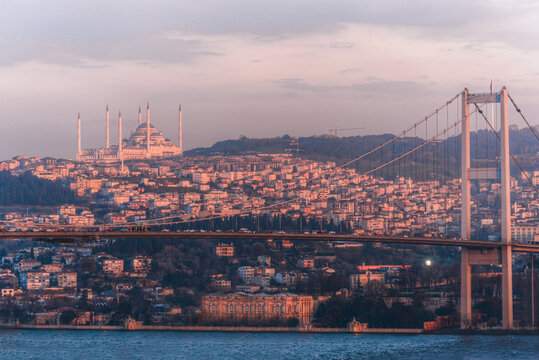 View of the Camlica Mosque overlooking the Bosphorus Bridge and the urban skyline at sunset in Istanbul, Istanbul, Turkiye.