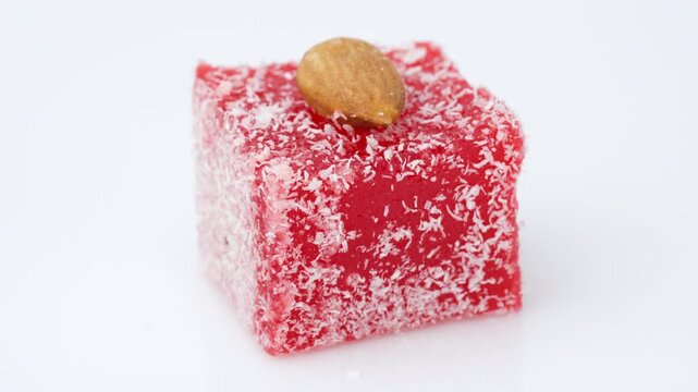 Assorted colorful Turkish delight sweets with nuts and coconut flakes rotating slowly close up. Rahat Lokum	
