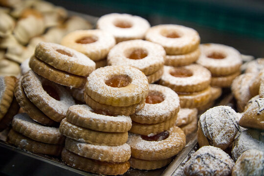 Assortment of delicious Sicilian pastries with almonds, chocolate drizzle, candied cherries and pistachio cream.