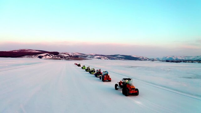 Line of Tractors Crossing a Vast Frozen Plain
