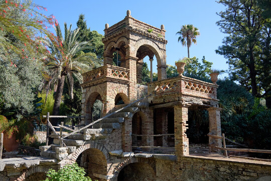A picturesque view of the historic Villa Comunale park in Taormina, showcasing its unique architecture and vibrant botanical gardens