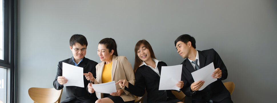 Group of professional businesspeople meeting and review documents in workplace. Teamwork, colleagues and employee, with businessmen and businesswomen working together in corporate business office