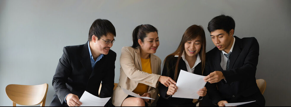 Group of professional businesspeople meeting and review documents in workplace. Teamwork, colleagues and employee, with businessmen and businesswomen working together in corporate business office