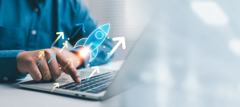 Business professional using a laptop with a digital rocket launch concept, representing business growth, startup success, innovation, strategy, expansion, progress, entrepreneurship, and technology.