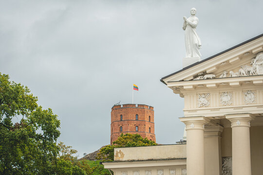 Gediminas Tower or Castle, the remaining part of the Upper Medieval Castle in Vilnius, Lithuania with Lithuanian flag on the top and the Cathedral in the foreground