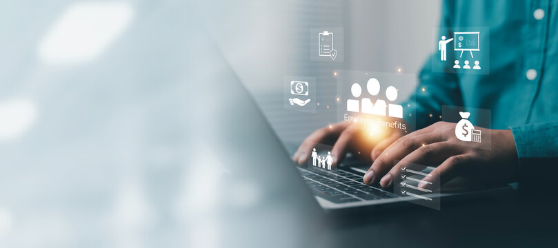 Business professional using a laptop with employee benefits icons, representing human resources, payroll, compensation, healthcare, financial planning, workforce management, and corporate technology.