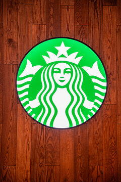 Bangkok, Thailand - September 4, 2026 : Starbuck Logo on Round light box at art wood pattern design in front of coffee cafe inside central world shopping mall.
