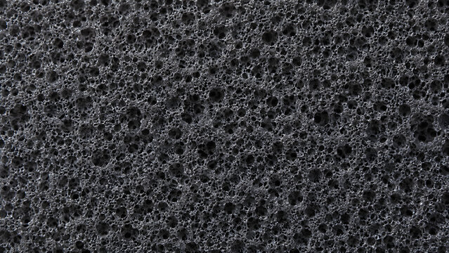 Black foam texture background, porous dark sponge material close up, industrial synthetic rubber surface for packaging
