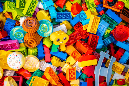 Top view A pile of multicolor of many Lego toy blocks in various shapes and different sizes. Toys and games. Leisure and recreation.
