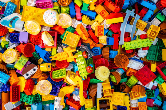 Top view A pile of multicolor of many Lego toy blocks in various shapes and different sizes. Toys and games. Leisure and recreation.