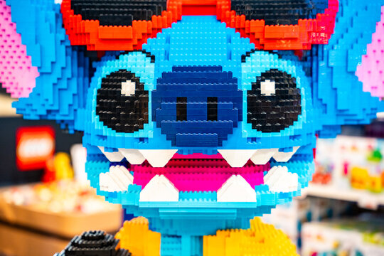 Bangkok, Thailand - September 4, 2026 : A large LEGO sculpture of Stitch from Disney Lilo & Stitch wearing sunglasses and a yellow shirt, holding a microphone.