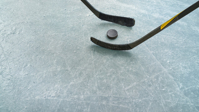  Ice hockey players on the ice hockey arena.  An ice surface as an ice rink with ice skates tracks.