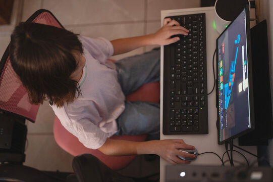 Kid playing at home video game in PC