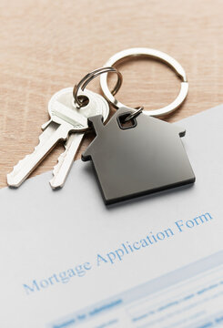 House keys resting on mortgage application form
