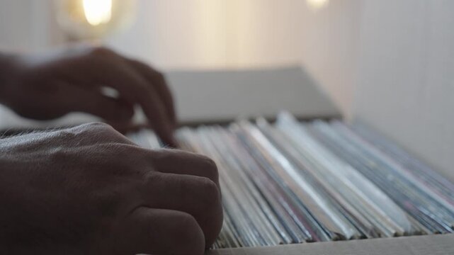 Hands Browsing Vinyl Record Collection in Cardboard Box