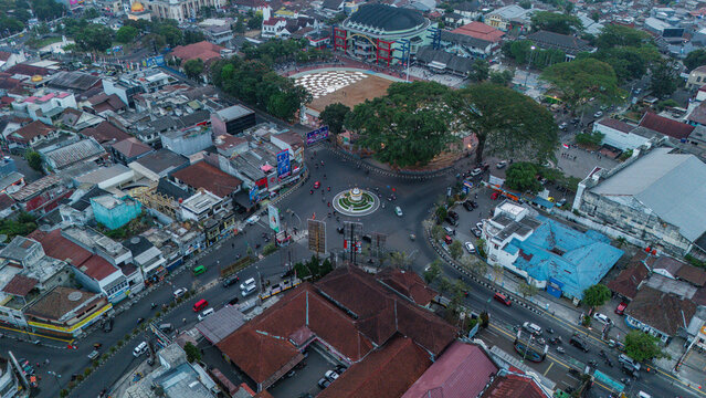 Aerial view of a busy city intersection with a roundabout, surrounding buildings, and urban traffic in Sukabumi, Indonesia.