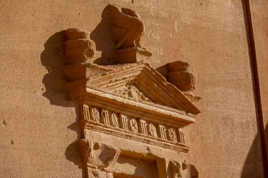 Weathered pediment with rosette carvings on a Nabataean tomb at Hegra, Al Madinah Province, Alula, Saudi Arabia