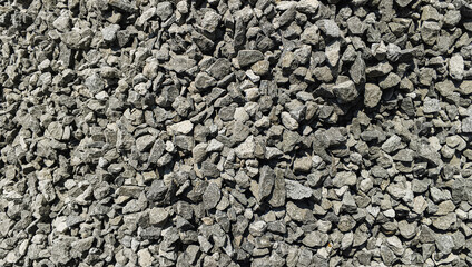 Full Frame Texture Of Rough Gray Crushed Stone In Bright Sunlight © Fikri Achmad