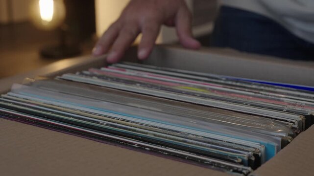 Hands Browsing Vinyl Record Collection in Cardboard Box