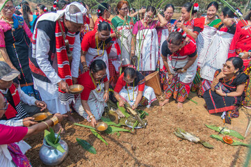Mising elders and women kneeling around to present rice, fish and traditional brew to Mother Earth during the Ali-Aye-Lhigang festival ritualsin Guwahati,Assam,India on 19 february 2025. © Kulajit