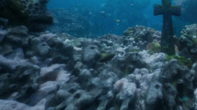 Bright blue waters offer a glimpse into an underwater landscape filled with colorful fish and unique rock formations. Sunlight filters through the waves, creating a serene atmosphere.