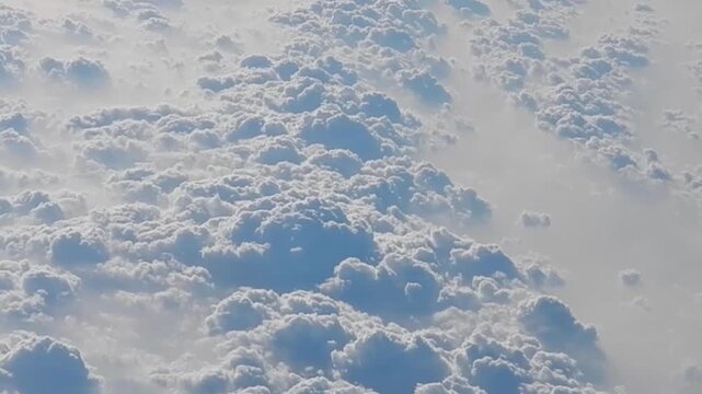 Natural abstract clouds background with white texture and pattern with Cumulus - aerial view over cloudy sky with sunlight. Topics: weather, meteorology, space, atmosphere, air travel