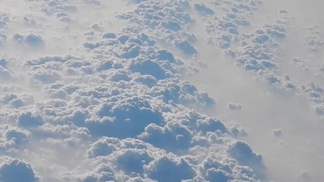 Natural abstract clouds background with white texture and pattern with Cumulus - aerial view over cloudy sky with sunlight. Topics: weather, meteorology, space, atmosphere, air travel