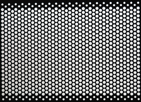 Black metal panel perforated with grid of small round white holes or dots. Monochrome minimalist abstract pattern and texture. Op art like optical illusion